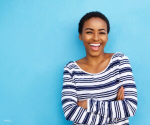 Young Black Woman With Beautiful Smile on Blue Background