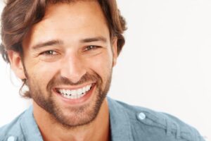 Smiling Man Showing Full Set of Healthy Teeth With No Gum Recession